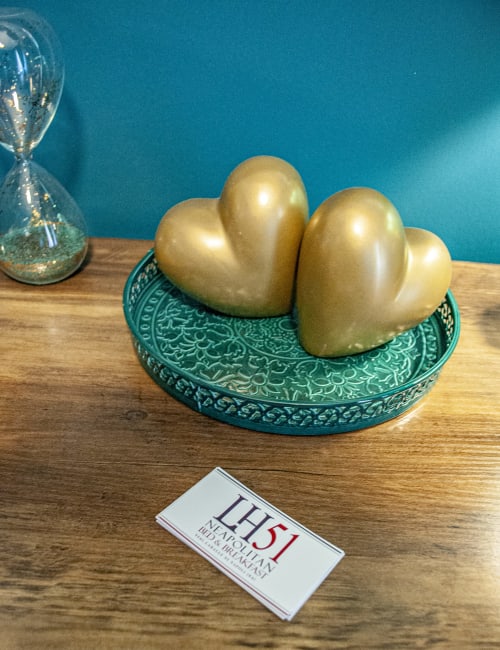 Gold heart decorations on turquoise plate at LH51 Rooms, Naples - Vesuvio's Room decor