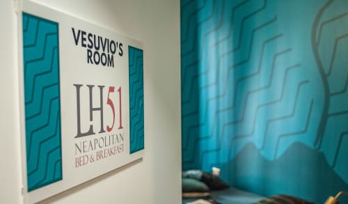 Vesuvio's Room sign at LH51 Neapolitan Bed & Breakfast in Naples, Italy, with turquoise geometric wall design