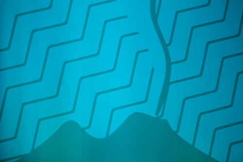 Abstract geometric blue wavy pattern with layered architectural design in Vesuvio's Room at LH51 Napoli