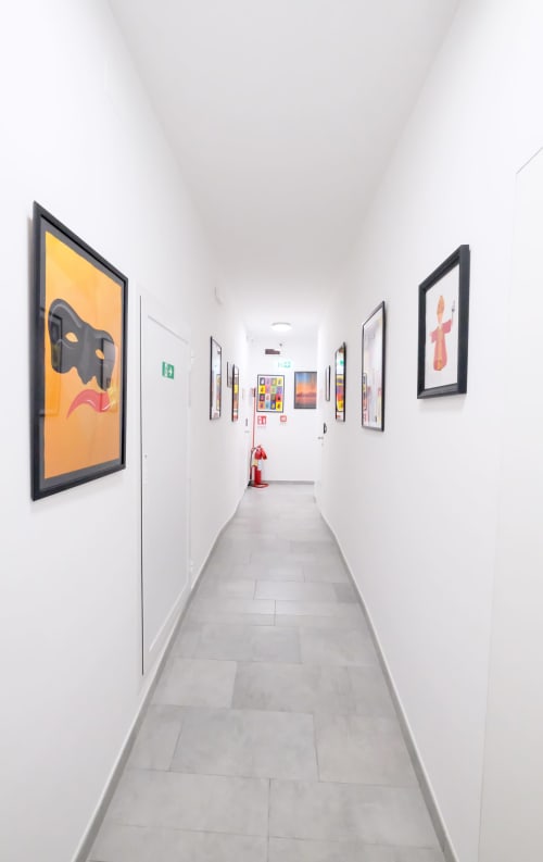 Modern hallway at LH51 Rooms in Naples with contemporary art, white walls, and emergency equipment