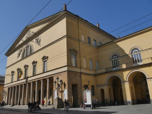 Palazzo Garibaldi hotel exterior in Parma with neoclassical architecture, columned portico, and warm stone facade