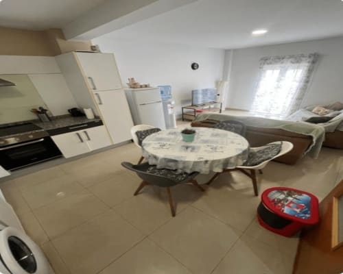 Open-plan apartment in Algemesí with kitchen, dining area, and living room featuring modern furnishings and natural light