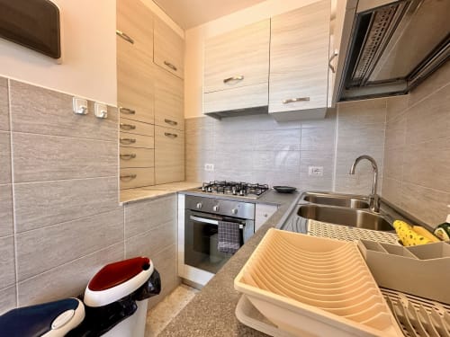 Cucina moderna dell'appartamento Casa Panorama a Welcome Varigotti, Finale Ligure con fornello a gas, lavello e mobili in legno