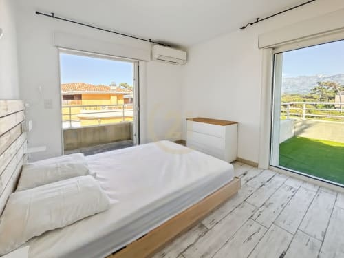 Chambre lumineuse avec vue mer à la Résidence Saint Philippe, L'Île-Rousse, literie blanche et mobilier moderne