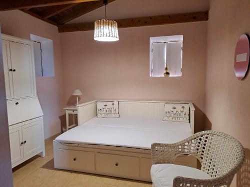 Bright bedroom at Inn Nature villa in São Roque do Pico with queen bed, white furniture, pink walls, and sea view window