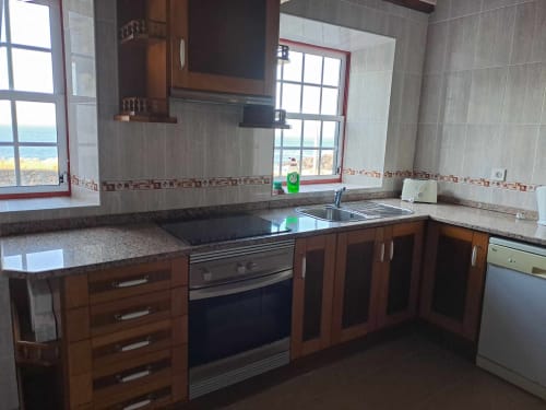 Modern kitchen with sea view at Inn Nature villa in São Roque do Pico, Portugal