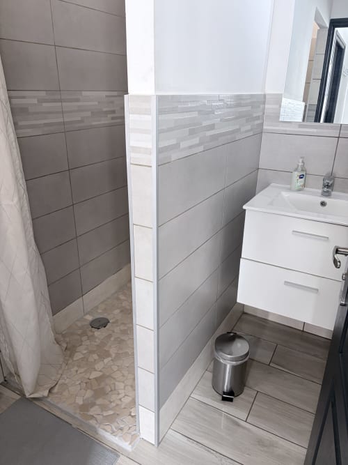 Modern bathroom with shower, white vanity, and tile flooring at Beach House Fos studio in Fos-sur-Mer