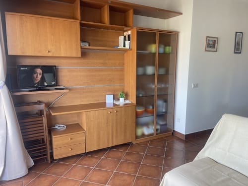 Sea View Garden apartment at Like at Home Palau featuring wooden furniture, TV, dining area, and terracotta flooring