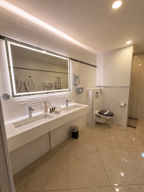 Salle de bains moderne à la Chambre La Milande du B&B La Biche Au Bois à Moncléra, avec double vasque, miroir lumineux et dressing