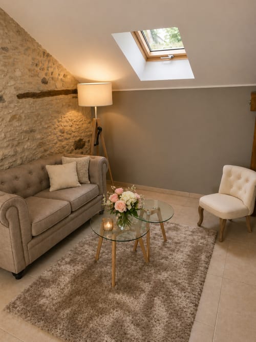 Cosy coin lounge au grenier de La Biche Au Bois, Suite la Cazalaise à Moncléra avec murs en pierre, puits de lumière et sièges rembourrés