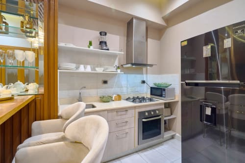 Modern kitchen in luxury downtown Santo Domingo apartment with white cabinetry, stainless steel appliances, gas cooktop, and