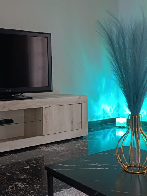 Moderno soggiorno nell'appartamento DUE ORIZZONTI, Atessa, con TV schermo piatto, consolle in legno e dettagli turchesi