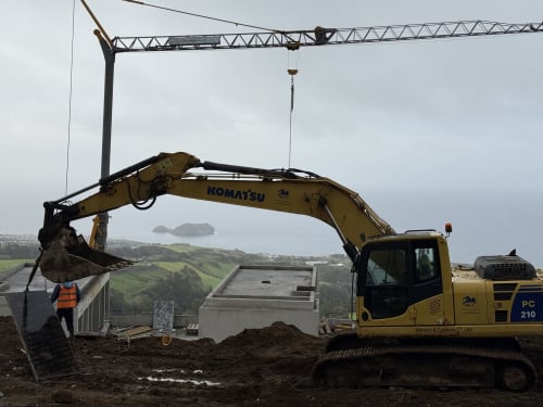 Komatsu excavator operating at Golden Mermaid Villa construction site in Ribeirinha, Portugal