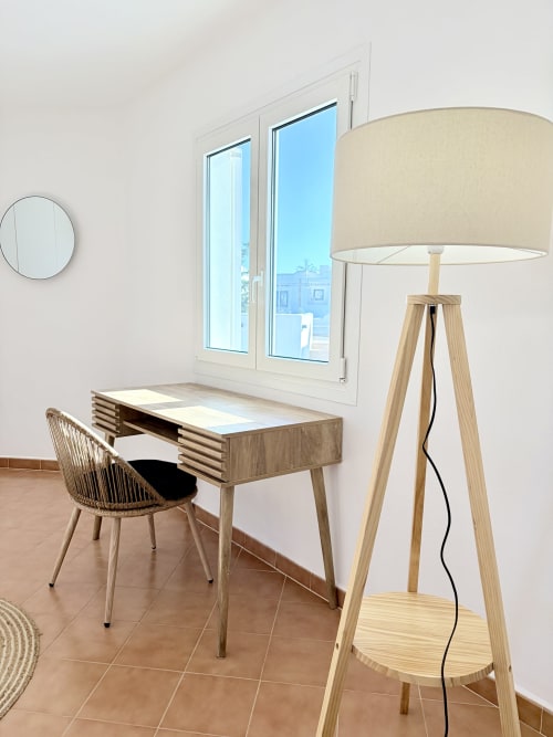 Modern workspace at Villa Alegria in Cala d'Or with wooden desk, woven chair, and floor lamp