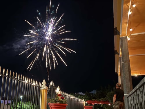Fireworks burst above Golden Mermaid Villa in Ribeirinha, Portugal during nighttime celebration