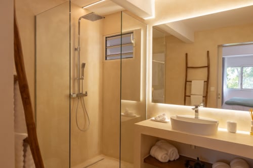 Salle de bain moderne à la Villa Agama avec douche en verre, vasque et porte-serviettes chauffant à Saint-Martin