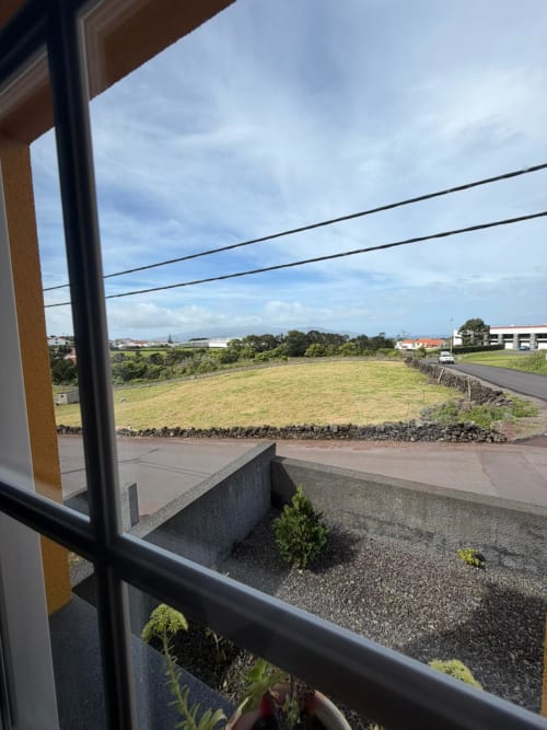 Rural countryside view from Casa da Avó Alice villa at Inn Nature, São Roque do Pico, with green fields and distant buildings
