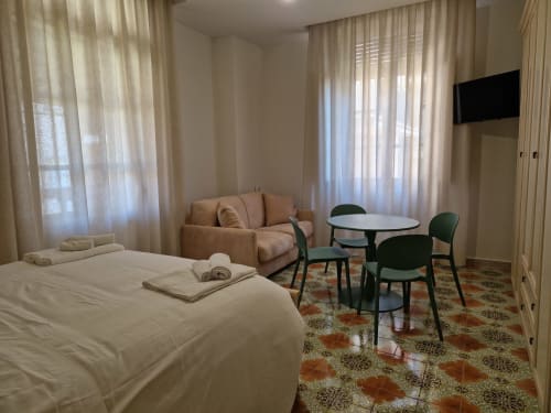 Camera moderna all'Il 900 B&B di Avezzano con letto, zona living e pavimento in piastrelle decorate