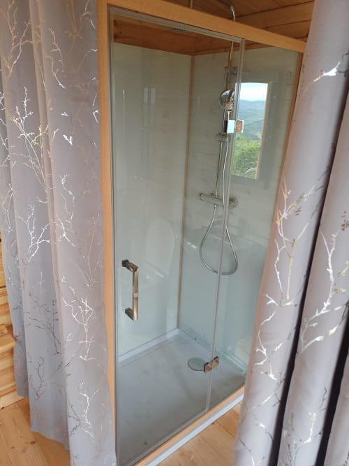 Modern glass shower enclosure in Douglas room at La Maison de Dun, Saint Racho, with mountain view window