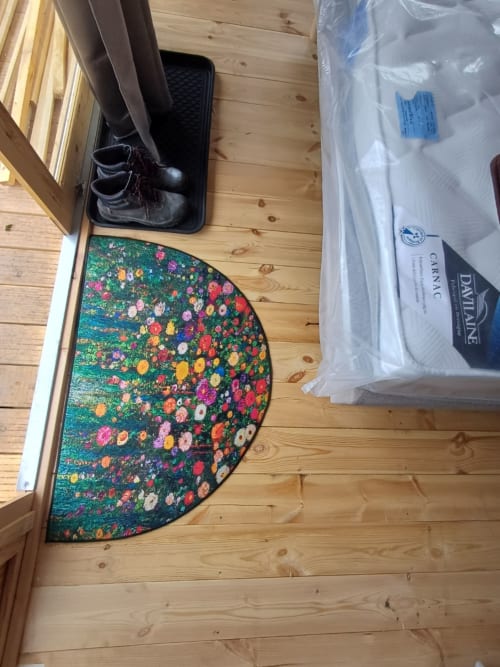 Colorful floral rug and packaged bedding in Douglas room at La Maison de Dun B&B, Saint Racho