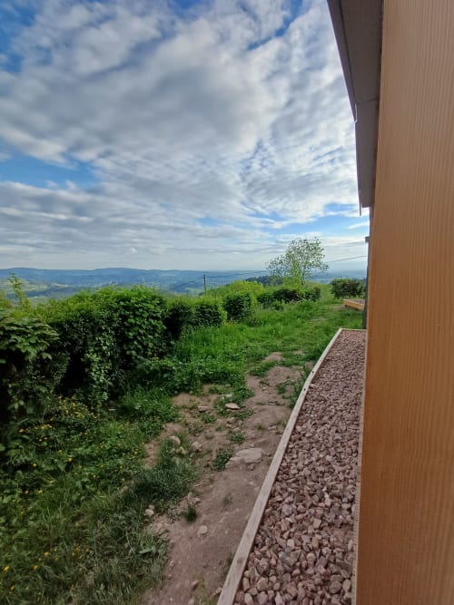 Mountain view from Douglas room at La Maison de Dun, Saint Racho, showing green countryside and rolling hills with blue sky