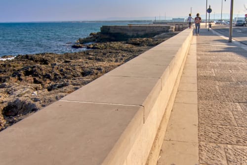 Waterfront promenade at Hotel De Lion Sur Mer with rocky coastline and blue Mediterranean Sea, Lion sur Mer France