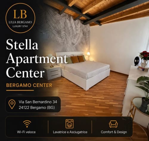Camera Stella a Bergamo con travi in legno, letto bianco, parete a spina di pesce e pavimento in legno presso Lilia Luxury Stay