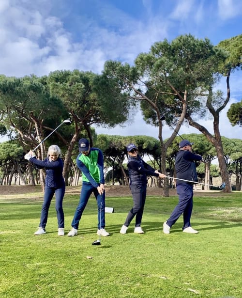 Four golfers at STAYnGOLF Cagnes-sur-Mer enjoying a round on a scenic course with Mediterranean trees