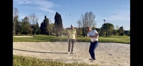 Golfers practicing in bunker at STAYnGOLF golf course in Cagnes sur Mer with manicured fairways and trees