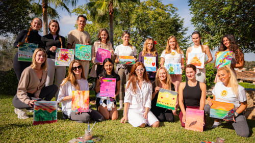 Groupe d'hôtes d'Agroturismo Ses Illes exposant des œuvres colorées en plein air à Costitx, Espagne