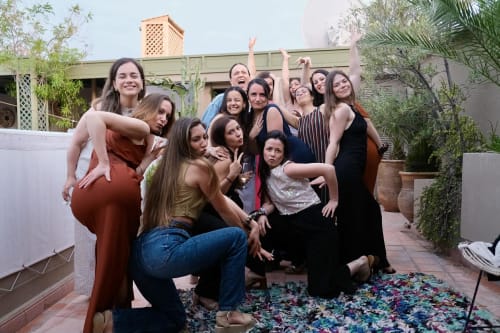 Group of women celebrating together in the courtyard of Riad 191, a traditional Moroccan riad hotel in Marrakech
