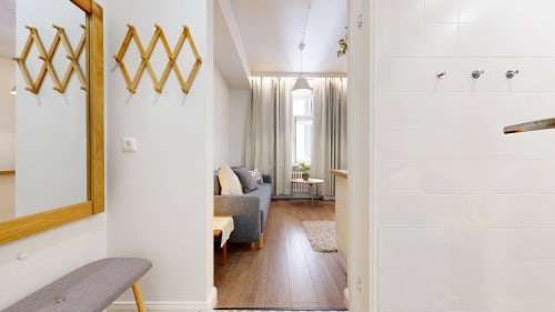 Modern apartment hallway with wooden accents, leading to bright sitting area at tARTu Stays City Center, Tartu