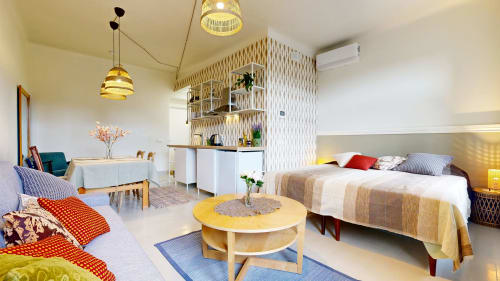 Modern studio apartment at tARTu Stays with bed, seating area, kitchenette, and yellow accents in Tartu city center