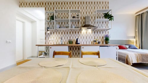 Modern studio apartment at tARTu Stays with kitchenette, dining area, and bed in Tartu city center