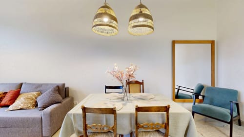 Modern dining area at tARTu Stays with round table, wooden chairs, pendant lights, and contemporary furniture in Tartu
