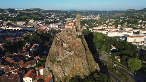 Paysage urbain du Puy-en-Velay avec la chapelle Saint-Michel au sommet d'une formation rocheuse dramatique, Maison Antea à proximité