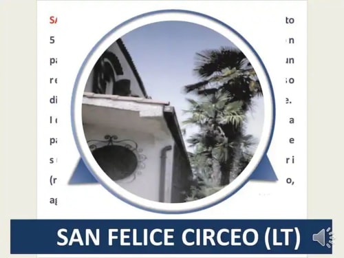 Esterno dell'hotel San Felice Circeo con architettura bianca e palme su cielo azzurro