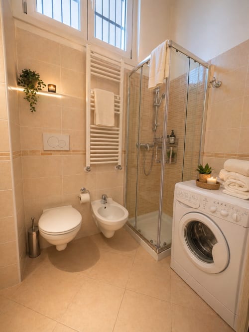 Modern bathroom in Loft 46 at Hb Hall Srl Milano with shower, toilet, bidet, washing machine, and heated towel rack