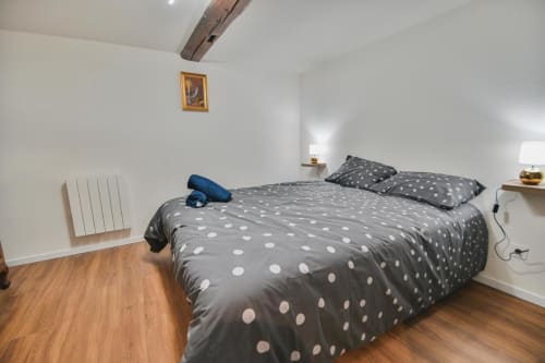 Chambre douillette au gîte Le Petit Havre de Joy à Dambach-la-Ville avec literie à pois et poutres en bois