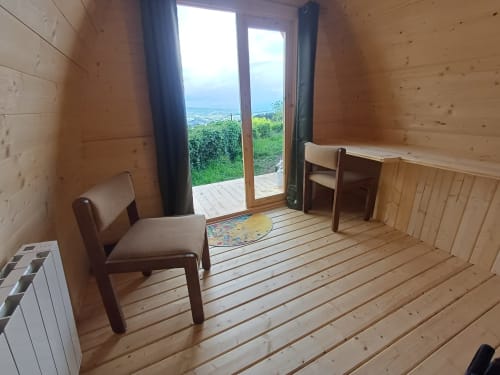 Pod Houx room at La Maison de Dun in Saint Racho with wooden interior, mountain view from glass doors