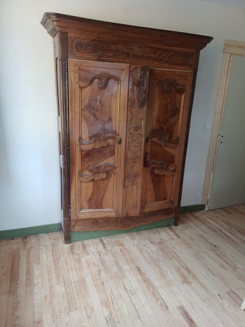 Ornate wooden armoire with carved details in OAK Familial room at La Maison de Dun, Saint Racho