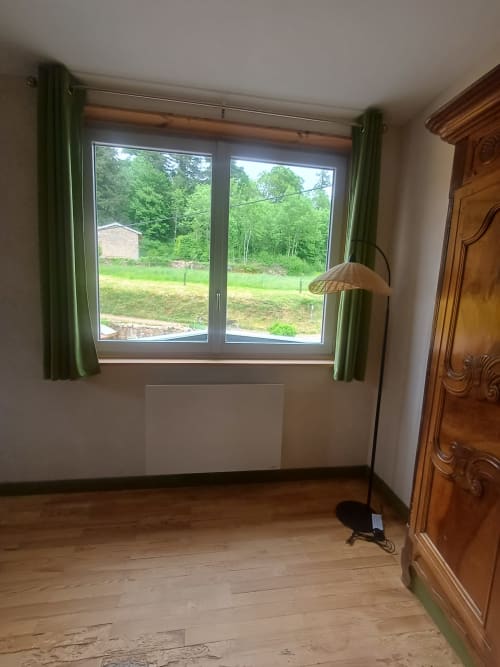 Oak Familial room at La Maison de Dun with garden view, wooden floors, green curtains, and wardrobe