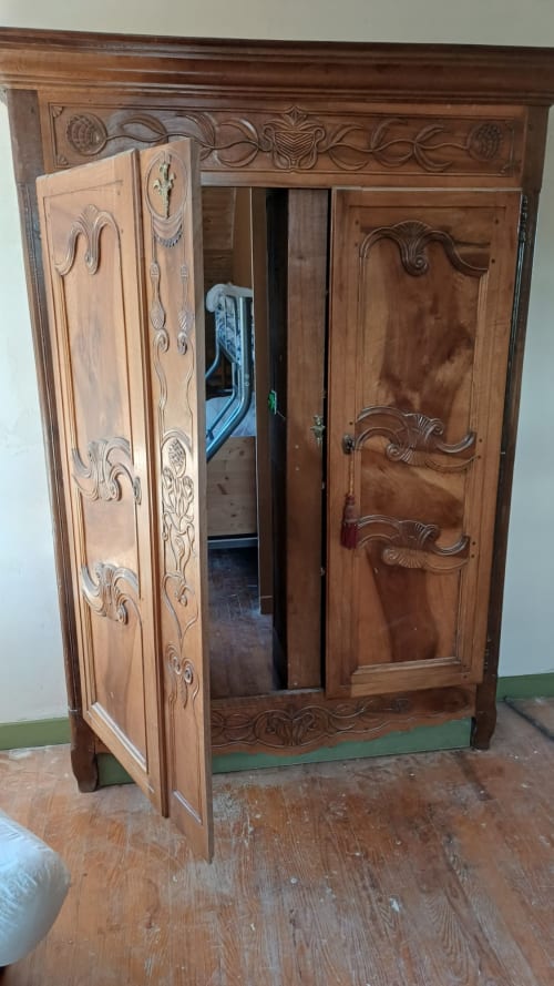 Ornate wooden wardrobe at La Maison de Dun B&B in Saint Racho, France