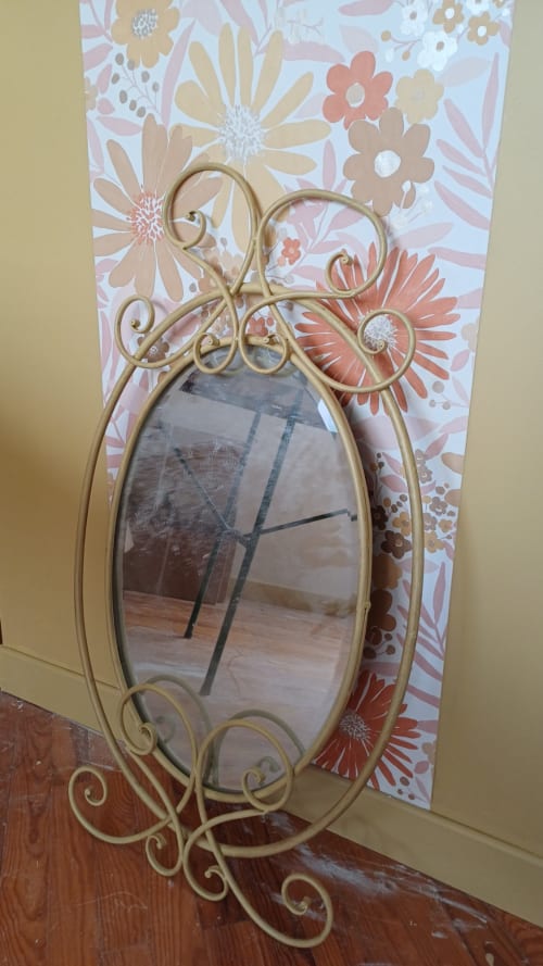 Ornate gold metal mirror with decorative scrollwork in Chambre Passiflore at La Maison de Dun, Saint Racho