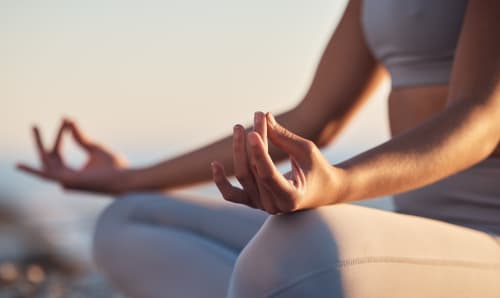 Person meditating in yoga pose at sunset, Domaine Alga bed and breakfast in Bourg-Charente, France