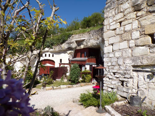 Entrée d'habitation troglodytique aux Troglos de Beaulieu à Beaulieu-les-Loches, avec murs de pierre et portes rouges