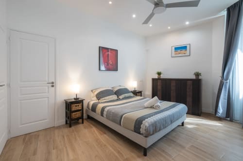 Zen apartment #4 at Enjoy Nice in Nice, France featuring a modern bedroom with striped bedding, dark wood furniture, and