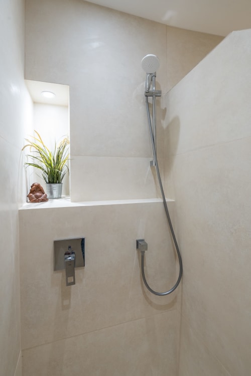Modern shower with rainfall head, chrome fixtures, and built-in niche at Enjoy Nice hotel in Nice, France
