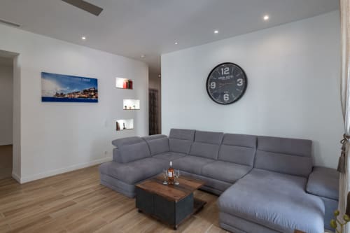 Modern gray sectional sofa with wood table in Zen apartment at Enjoy Nice hotel in France
