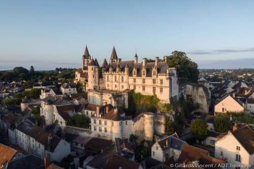 Neuschwanstein-style castle overlooking medieval town near Les Troglos de Beaulieu, Loches